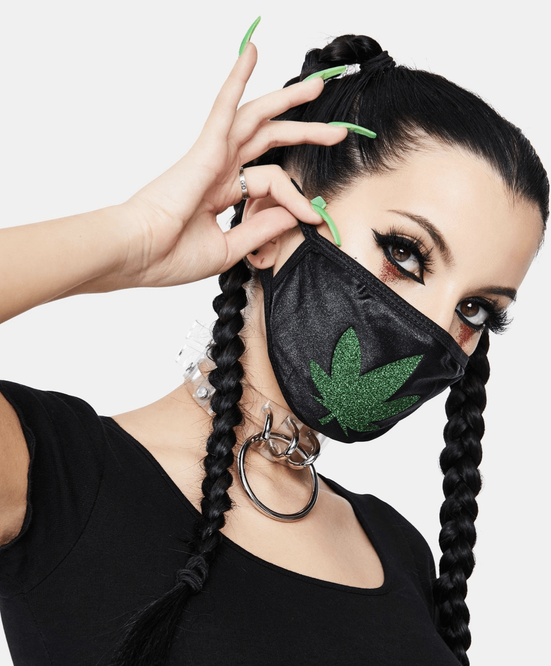 Model wearing black face mask with a green glitter weed leaf for a finished look