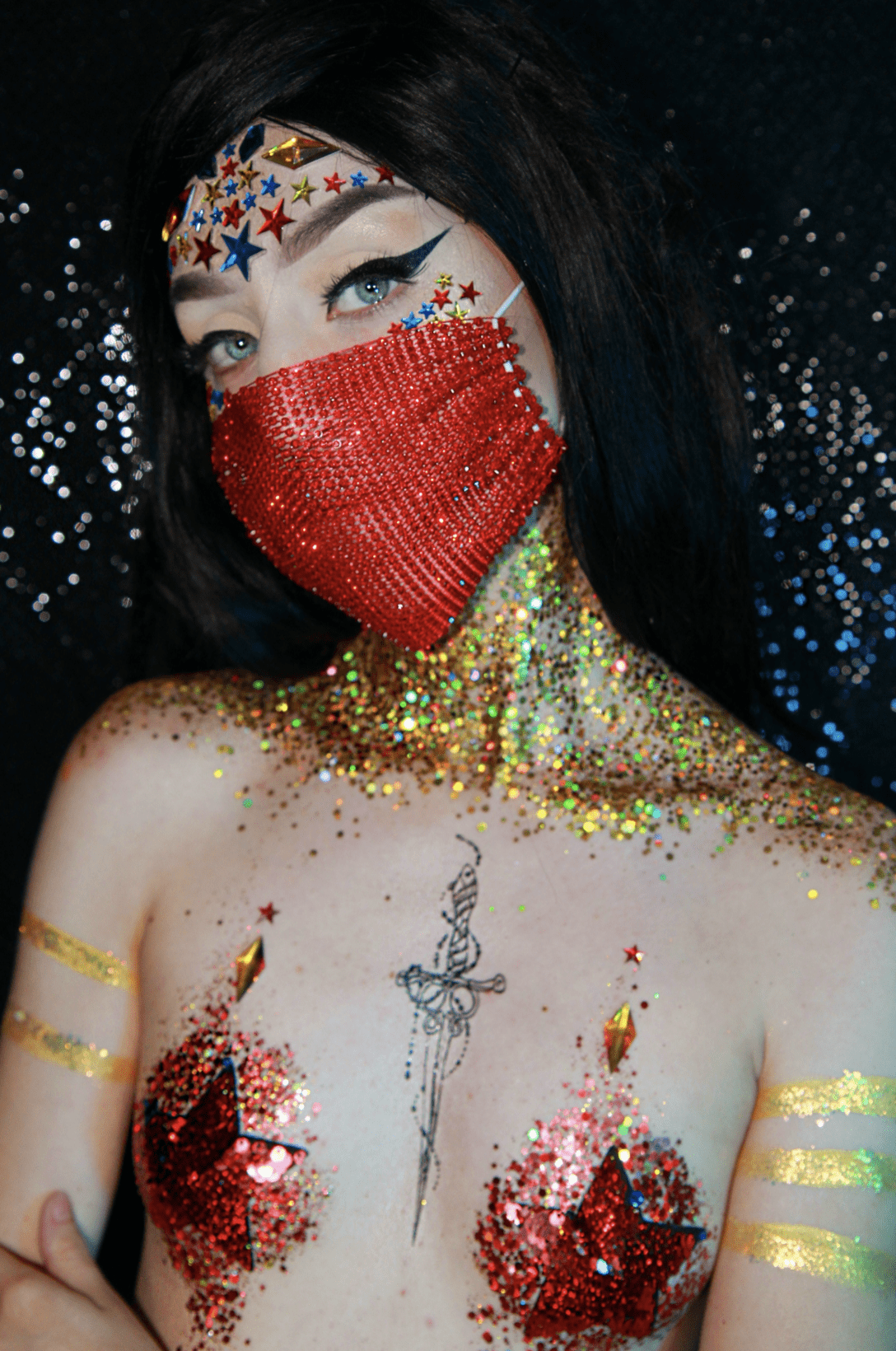 Red superhero costume bundle with mask, pasties and glitter shown together