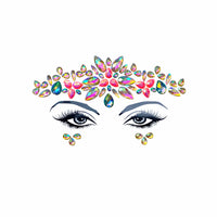 Overhead view of pink and blue crystal tiara face jewels set against a simple background