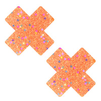 View of the orange glitter cotton candy X nipple pasties showing the overall design and color