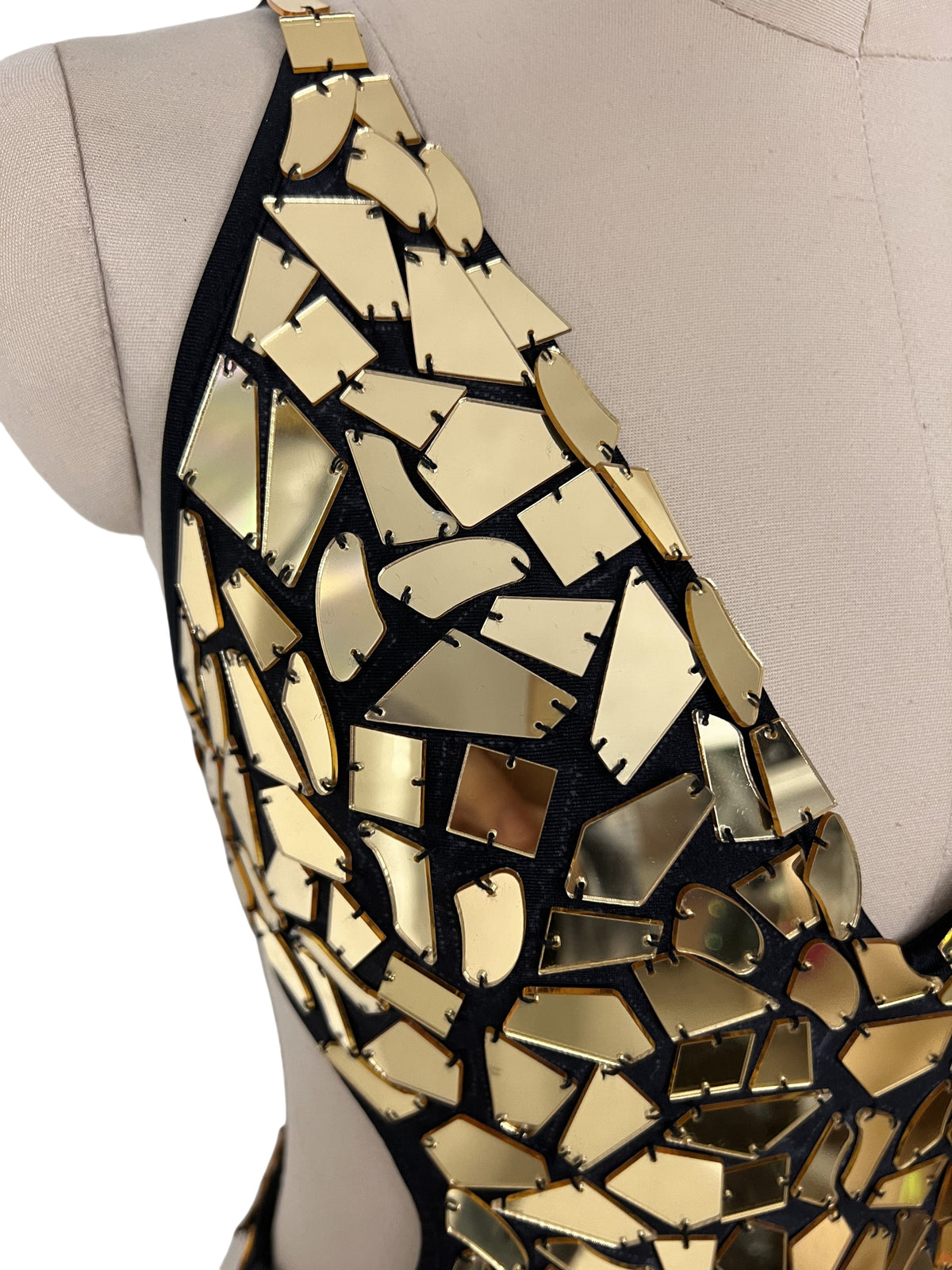 Shiny gold mirror tile one piece bodysuit with a sleek futuristic look
