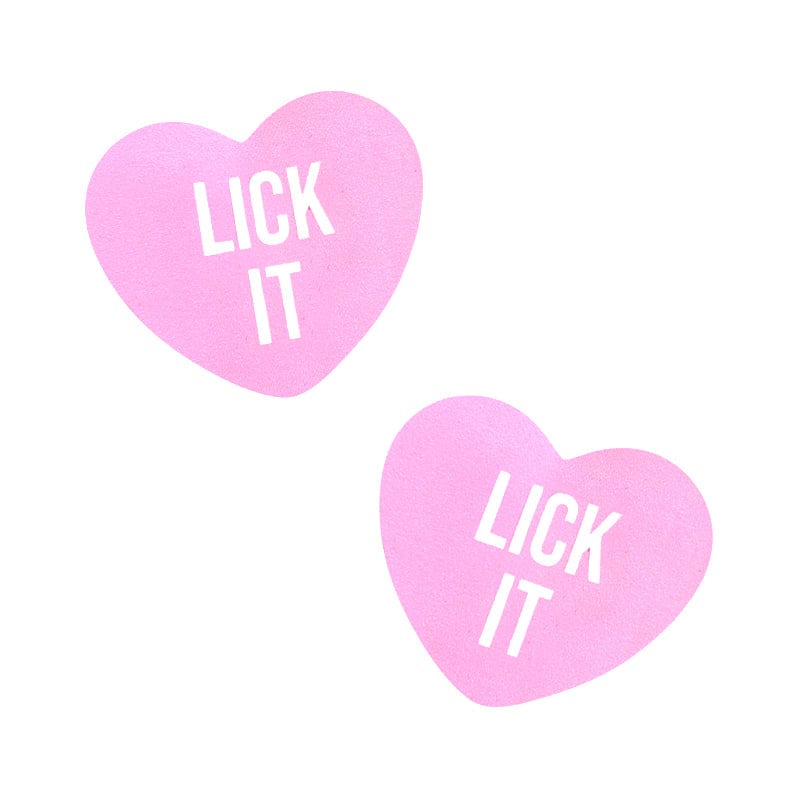 Pair of soft pink candy heart shaped nipple covers with bold printed lettering