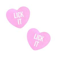 Pair of soft pink candy heart shaped nipple covers with bold printed lettering