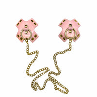 Reusable pink faux leather nipple covers linked by a silver metal chain