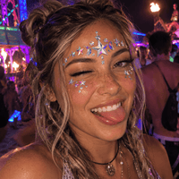 Iridescent moon and stars crystal face jewels worn in a playful neon festival selfie