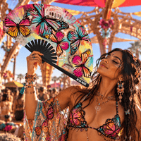 Multicolor butterfly blacklight reactive folding fan glowing in a festival scene