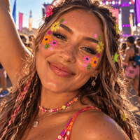 Close up detail of the colors on neon glitter daisy face sticker with jewels