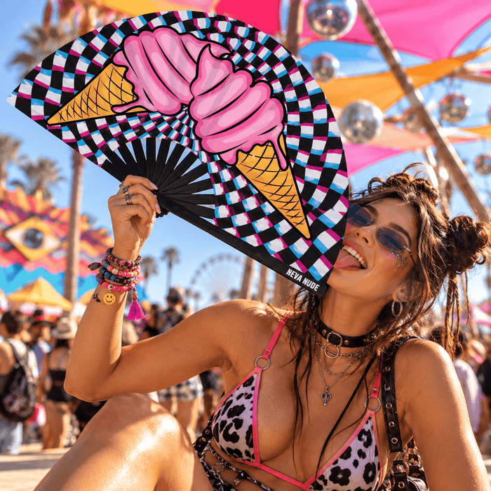 Pink ice cream checkered folding fan held playfully at a colorful festival