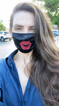 Front view of black face mask with red glitter lips with the full design visible