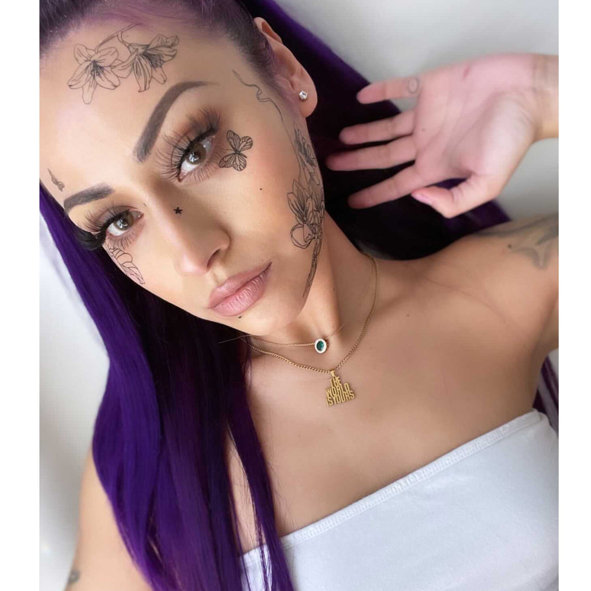 Model wearing black floral large temporary tattoos for a finished look