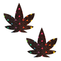 Black glitter weed leaf pasties with holographic hearts shown on a clean background