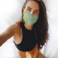 Model wearing the green and yellow crystal mesh jewel face mask at a neon rave