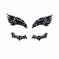 Close look at glossy black rhinestone wing shaped face jewels for night looks
