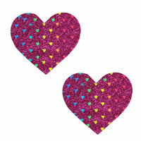Dark pink glitter heart nipple pasties with rainbow foil shown on a clean background