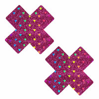 Dark pink glitter X nipple pasties with rainbow hearts shown on a clean background
