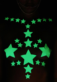 Model wearing glow in the dark star nipple sticker crop top made for night raves