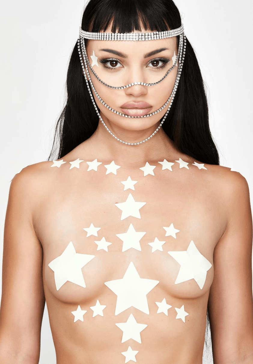 Glow in the dark star nipple sticker crop top worn by a model with a soft green yellow glow