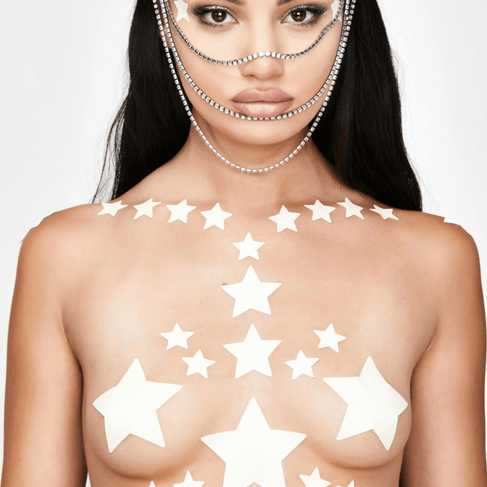 Glow in the dark star nipple sticker crop top worn by a model with a soft green yellow glow