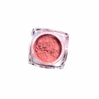 Product shot of pale pink shimmer loose pigment eyeshadow in a sweet pastel shade