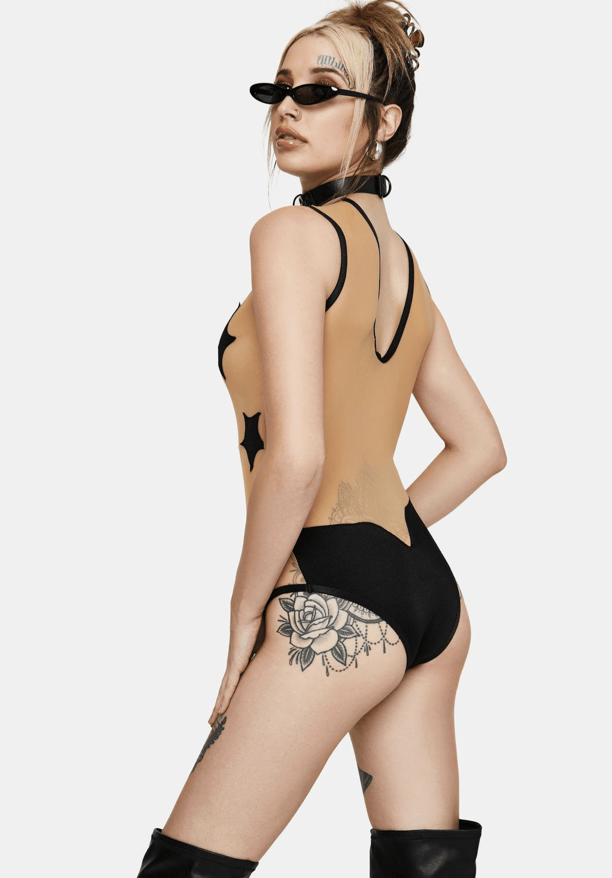 Model wearing the black star mesh bodysuit for a night out look