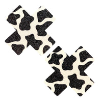 Cow print glitter holographic X shaped nipple pasties shown on their own