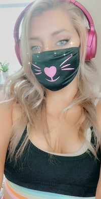 Black face mask with neon pink kitty whiskers that glow under blacklight worn by a model
