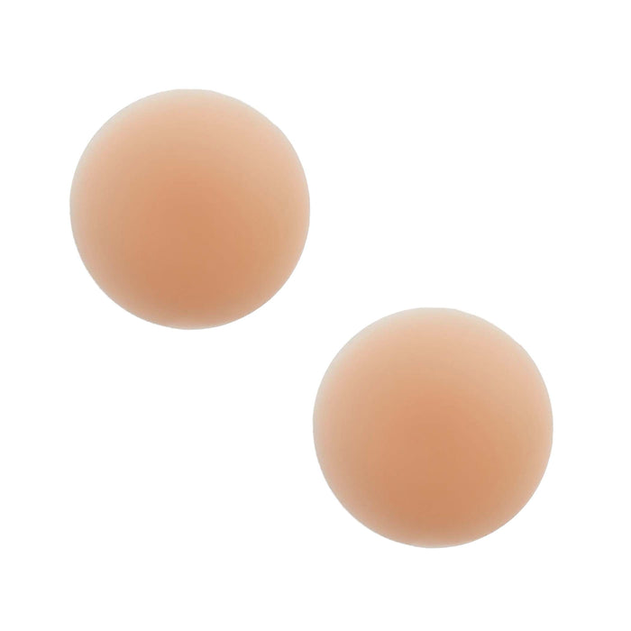 Overhead view of nude invisible reusable silicone nipple covers set against a simple background