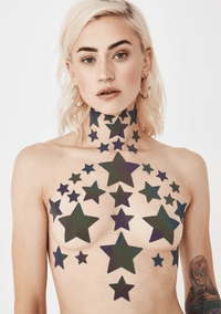Grey rainbow reflective star nipple sticker crop top worn by a model that flashes rainbow under light
