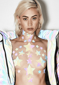 Model wearing grey rainbow reflective star nipple sticker crop top with a bright reflective finish
