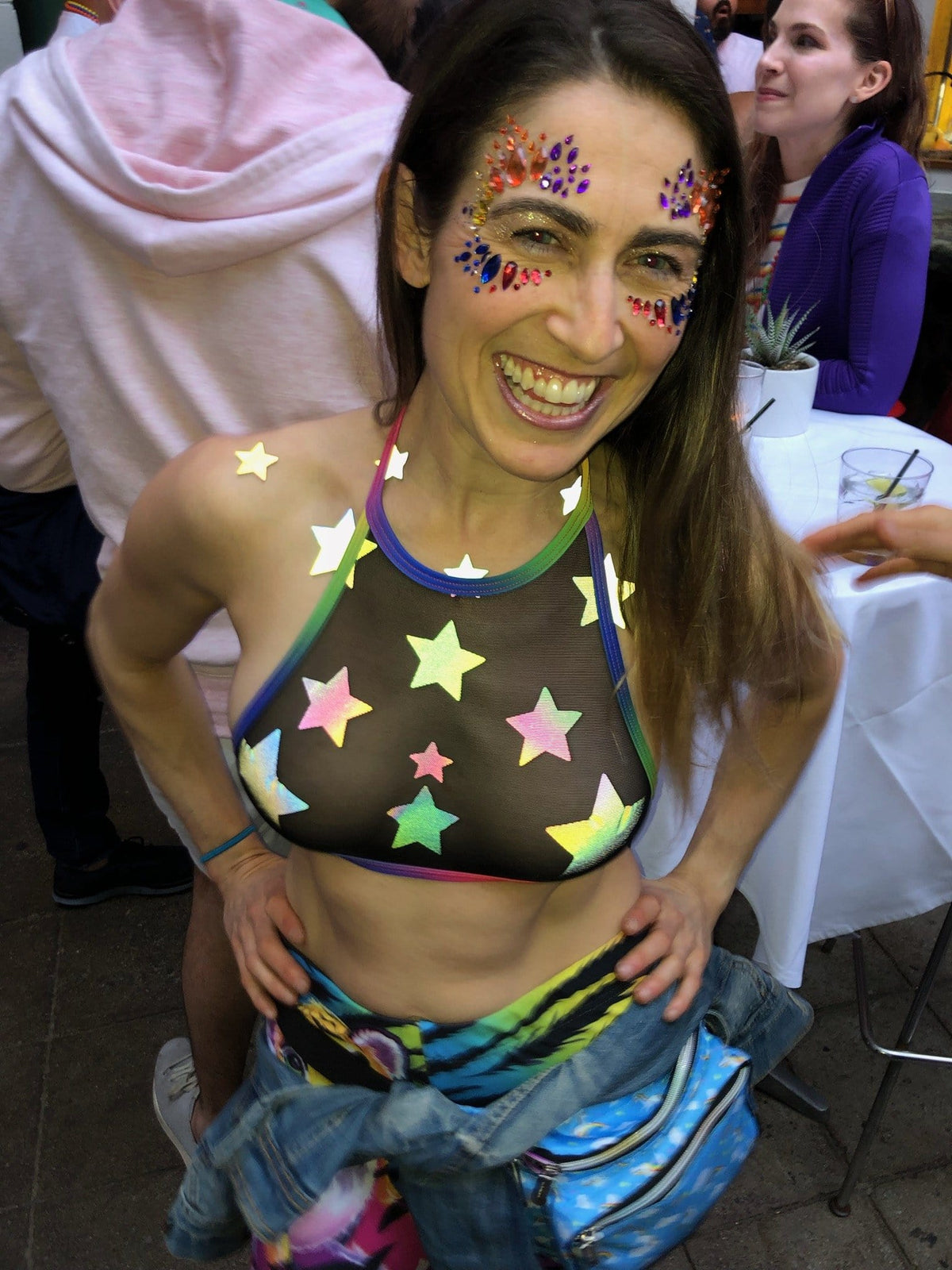 Grey rainbow reflective star nipple sticker crop top styled on a model in soft grey with hidden rainbow shine