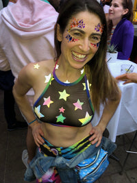 Grey rainbow reflective star nipple sticker crop top styled on a model in soft grey with hidden rainbow shine