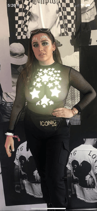 Model in gray reflective star nipple stickers forming a crop top for raves