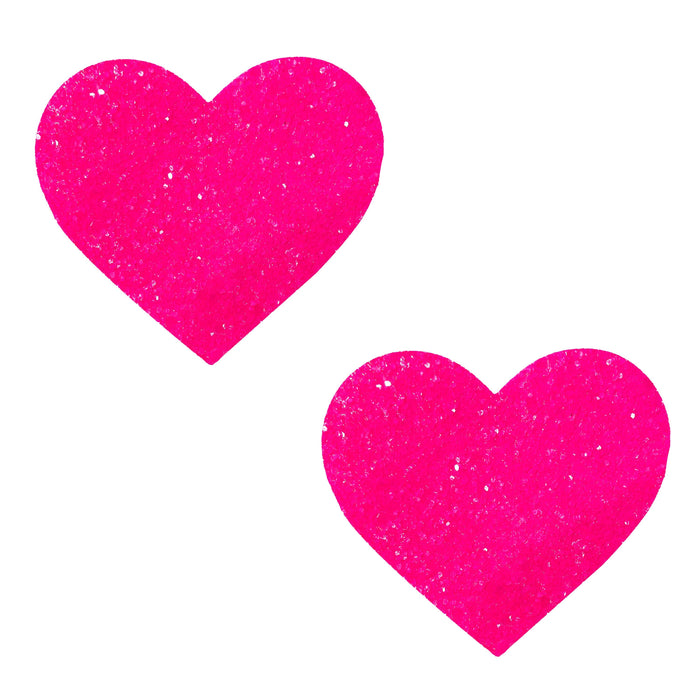Hot pink blacklight glitter heart nipple pasties shown on a clean background