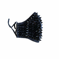 Side view of the black studded face mask with silver spikes and adjustable loops