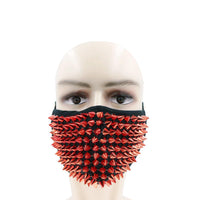 Side view of the red studded face mask with sharp spikes and adjustable loops