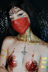 Red superhero costume bundle with mask, pasties and glitter shown together