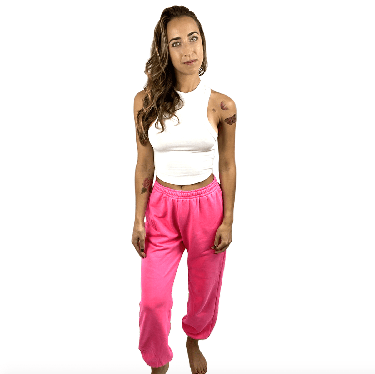 Pink neon jogger sweatpants shown in a relaxed oversized fit