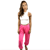 Pink neon jogger sweatpants shown in a relaxed oversized fit