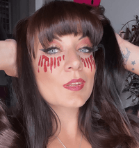 View of the red glitter blood tears face sticker showing the overall design and color