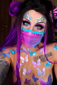 Pink and blue holographic face mask with matching pasties styled on a model to show fit and placement