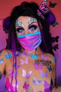 Pink and blue holographic face mask with matching pasties worn by a model