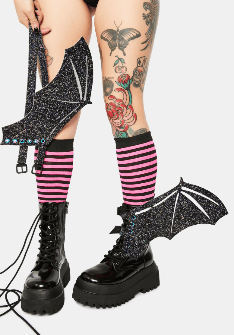 Model wearing the black glitter reflective bat wings on her boots