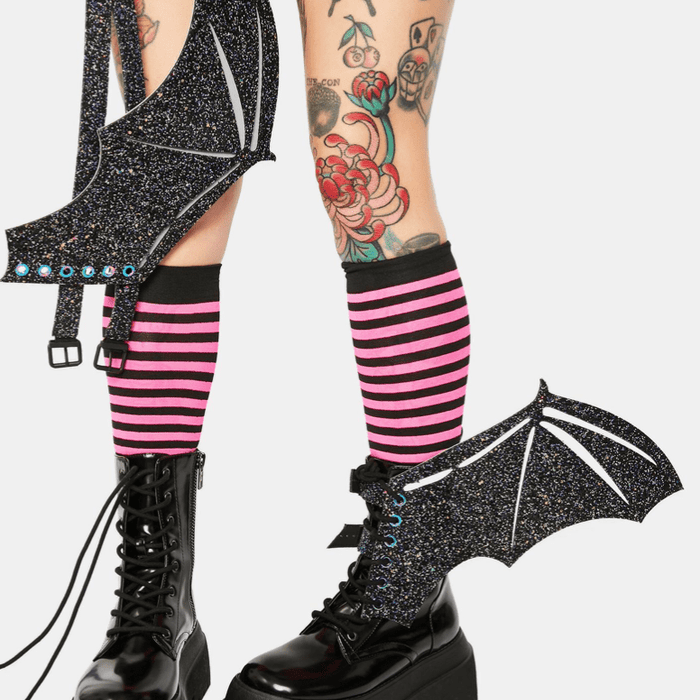 Model wearing the black glitter reflective bat wings on her boots