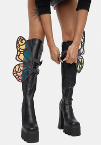 Model showing off the rainbow butterfly boot wings at a festival