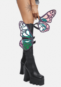 Model rocking the rainbow reflective butterfly boot wings for a fairy festival