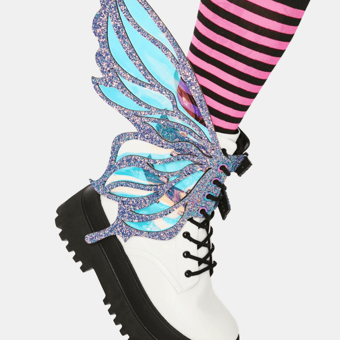 Model showing off the dark purple fairy boot wings at a festival
