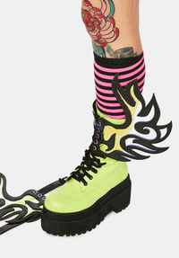 Model wearing the iridescent flame wings on her boots for a biker look