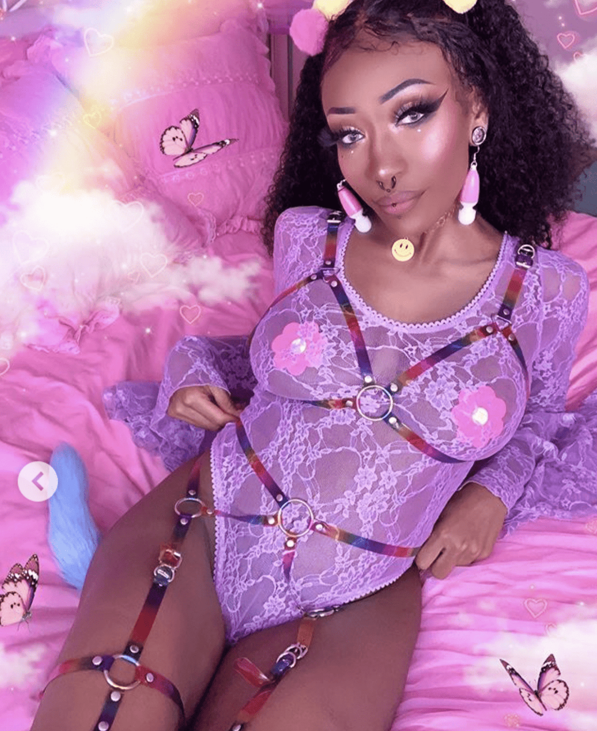 Model wearing hot pink blacklight glitter flower petal nipple pasties for a finished look